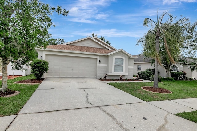 4129 Marlow Loop, Land O Lakes, FL 34639 - ranch-style house with a garage, a front lawn, concrete driveway, stucco siding, and roof with shingles