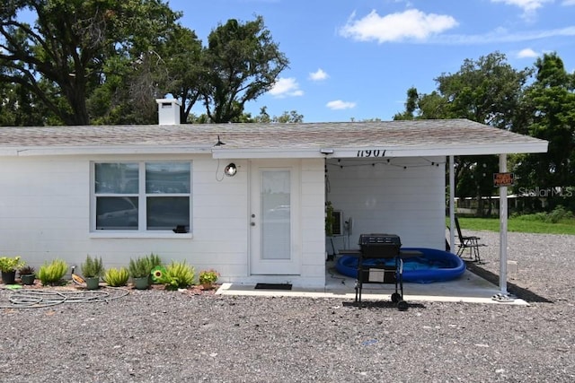 11907 Frontage Rd, Dade City, FL 33525 - view of front of property with a chimney and a shingled roof