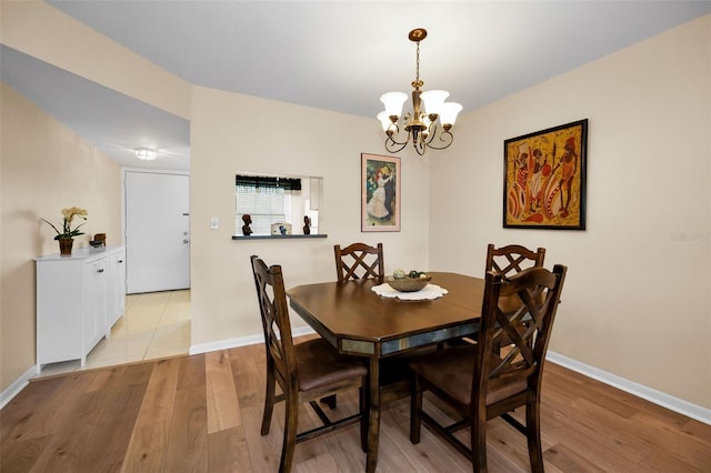 960 Virginia St Unit 204, Dunedin, FL 34698 - dining room with light wood-style flooring and a chandelier