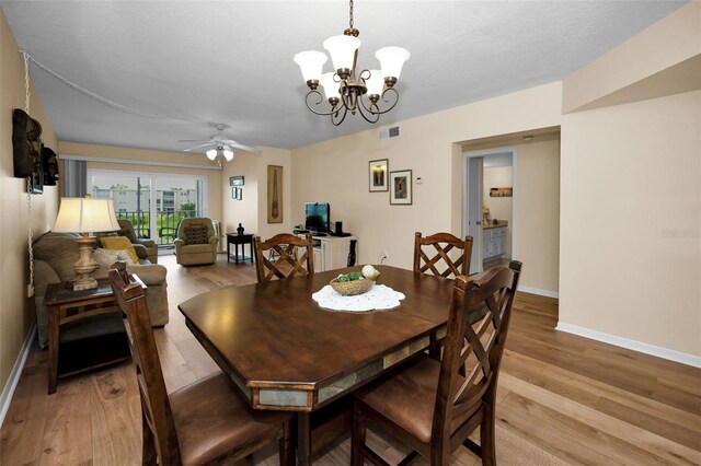 960 Virginia St Unit 204, Dunedin, FL 34698 - dining area with light wood finished floors, ceiling fan, and a chandelier