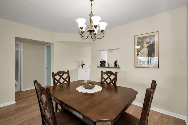 960 Virginia St Unit 204, Dunedin, FL 34698 - dining space featuring wood finished floors and a chandelier