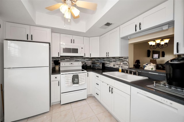 960 Virginia St Unit 204, Dunedin, FL 34698 - kitchen featuring white appliances, dark countertops, ceiling fan, white cabinetry, and light tile patterned floors