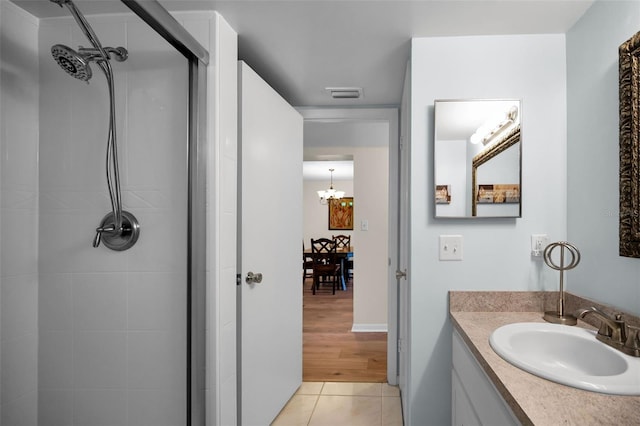 960 Virginia St Unit 204, Dunedin, FL 34698 - full bathroom with tiled shower, a chandelier, vanity, and tile patterned floors