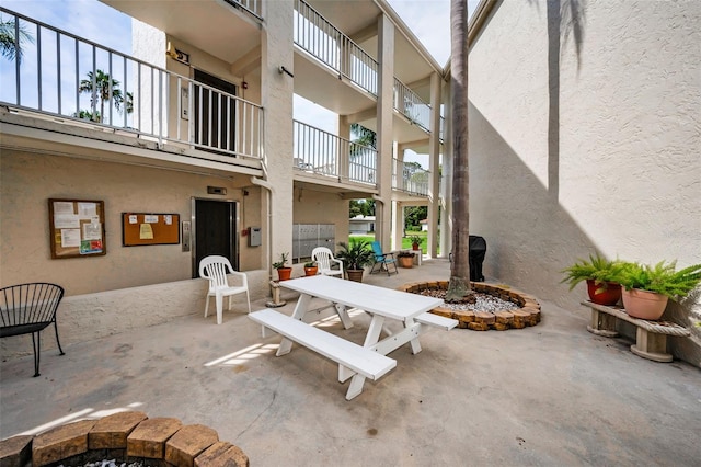 960 Virginia St Unit 204, Dunedin, FL 34698 - view of patio / terrace featuring outdoor dining area and a fire pit