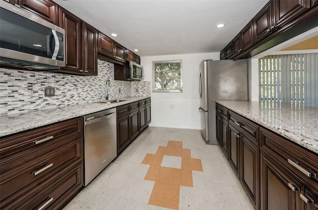 960 Virginia St Unit 204, Dunedin, FL 34698 - kitchen with appliances with stainless steel finishes, backsplash, dark brown cabinets, light floors, and recessed lighting