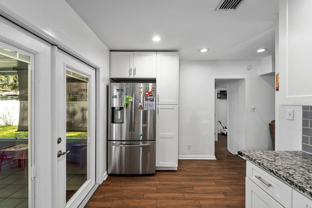7003 Yule Ln, Tampa, FL 33637 - kitchen with stainless steel refrigerator with ice dispenser, dark wood finished floors, dark stone countertops, white cabinets, and recessed lighting