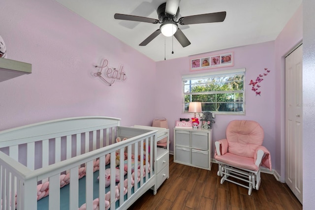 7003 Yule Ln, Tampa, FL 33637 - bedroom with a crib, wood finished floors, and a ceiling fan