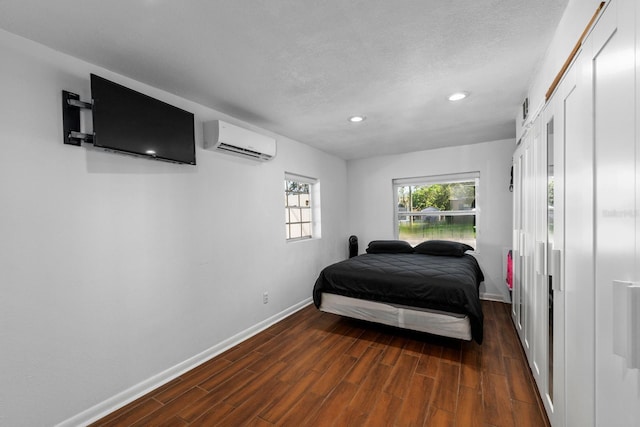 7003 Yule Ln, Tampa, FL 33637 - bedroom featuring a wall mounted AC, wood finished floors, recessed lighting, and a textured ceiling