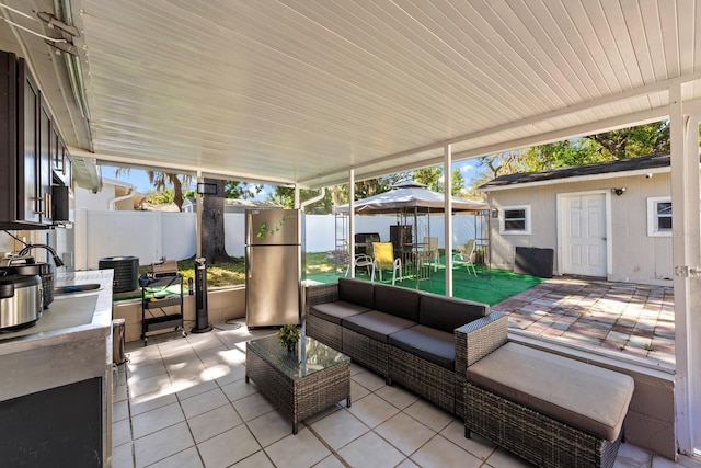 7003 Yule Ln, Tampa, FL 33637 - fenced backyard featuring outdoor dining area, a patio area, outdoor lounge area, a gazebo, and an outbuilding