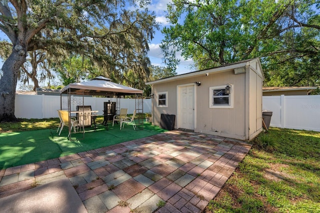 7003 Yule Ln, Tampa, FL 33637 - rear view of property featuring a gazebo, a fenced backyard, and a patio