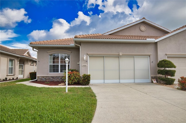 8354 Palmetto Ct, Englewood, FL 34224 - mediterranean / spanish house with a garage, driveway, a front lawn, and stucco siding