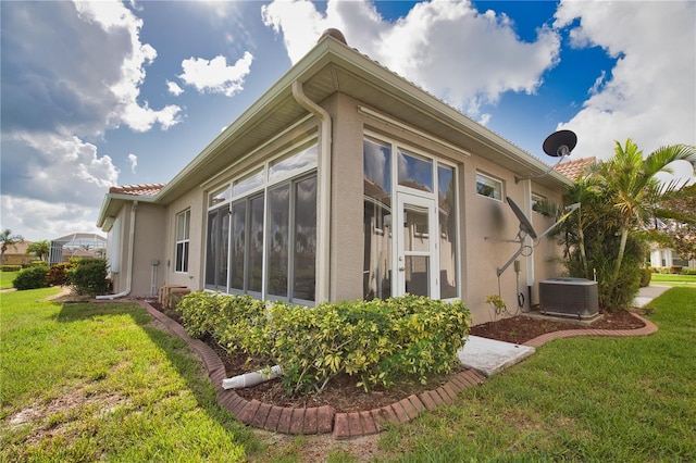 8354 Palmetto Ct, Englewood, FL 34224 - view of property exterior featuring stucco siding, a lawn, and a tiled roof