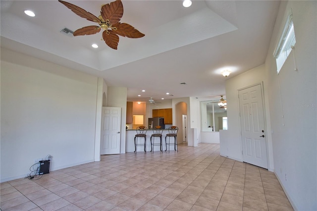 8354 Palmetto Ct, Englewood, FL 34224 - unfurnished living room with a ceiling fan, recessed lighting, arched walkways, and light tile patterned floors