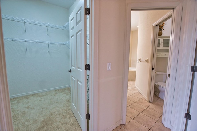 8354 Palmetto Ct, Englewood, FL 34224 - walk in closet with light tile patterned flooring