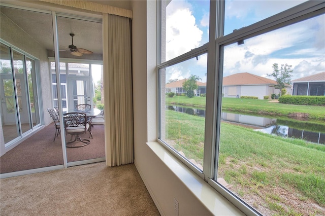 8354 Palmetto Ct, Englewood, FL 34224 - sunroom / solarium featuring carpet flooring, a water view, a ceiling fan, and plenty of natural light