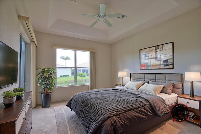 8354 Palmetto Ct, Englewood, FL 34224 - bedroom featuring light colored carpet, a raised ceiling, and a ceiling fan