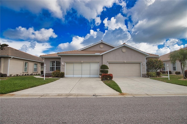 8354 Palmetto Ct, Englewood, FL 34224 - mediterranean / spanish house featuring driveway, a garage, a front lawn, a tiled roof, and stucco siding