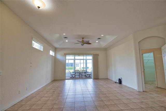 8354 Palmetto Ct, Englewood, FL 34224 - unfurnished room featuring healthy amount of natural light, a ceiling fan, light tile patterned flooring, recessed lighting, and a tray ceiling