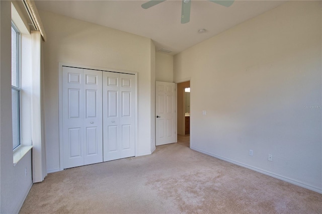 8354 Palmetto Ct, Englewood, FL 34224 - unfurnished bedroom featuring light carpet, a closet, and a ceiling fan