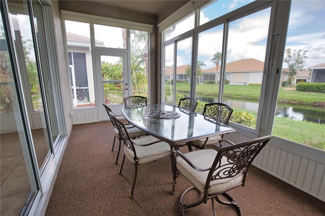 8354 Palmetto Ct, Englewood, FL 34224 - sunroom / solarium featuring a water view, outdoor dining space, and carpet