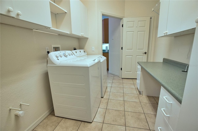 8354 Palmetto Ct, Englewood, FL 34224 - laundry area featuring cabinet space, washer and clothes dryer, and light tile patterned floors