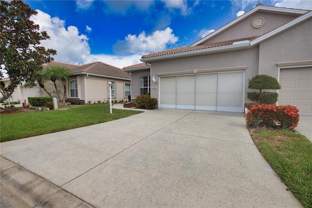 8354 Palmetto Ct, Englewood, FL 34224 - mediterranean / spanish house featuring a tiled roof, stucco siding, a garage, and a front yard