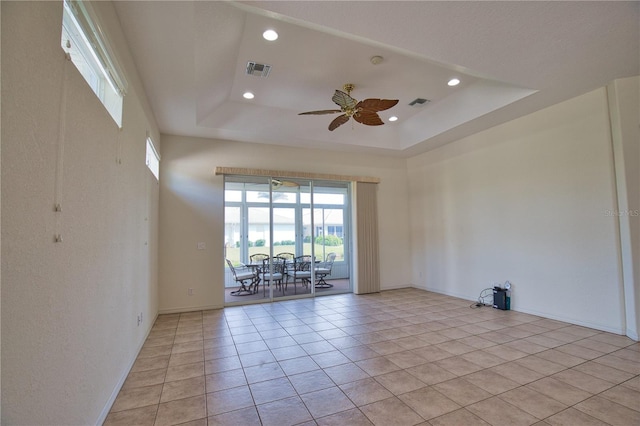 8354 Palmetto Ct, Englewood, FL 34224 - unfurnished room featuring ceiling fan, recessed lighting, light tile patterned floors, and a tray ceiling