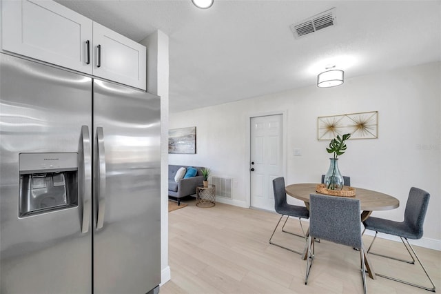 8045 Colton Dr, Port Richey, FL 34668 - dining room featuring baseboards and light wood finished floors