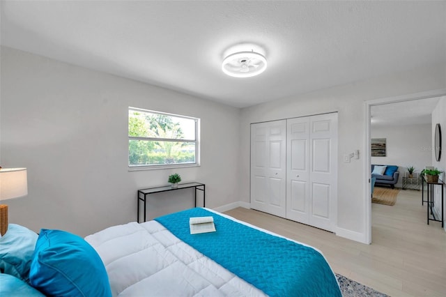 8045 Colton Dr, Port Richey, FL 34668 - bedroom with light wood-style floors and a closet