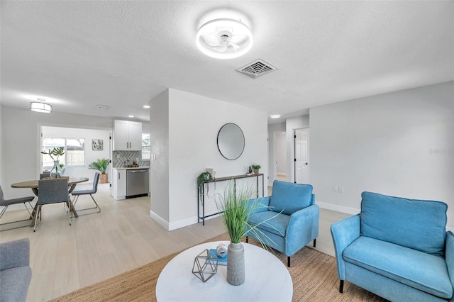 8045 Colton Dr, Port Richey, FL 34668 - living room with light wood-type flooring, a textured ceiling, and recessed lighting
