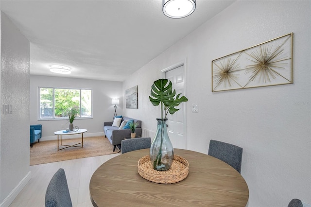 8045 Colton Dr, Port Richey, FL 34668 - dining space featuring baseboards and wood finished floors