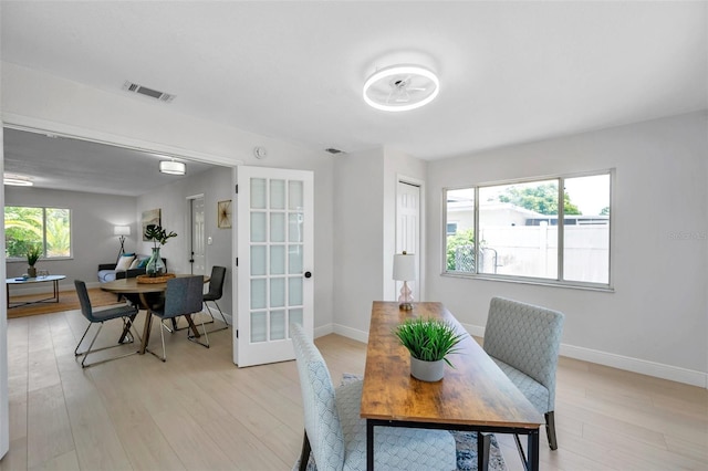 8045 Colton Dr, Port Richey, FL 34668 - dining space with light wood-type flooring and baseboards