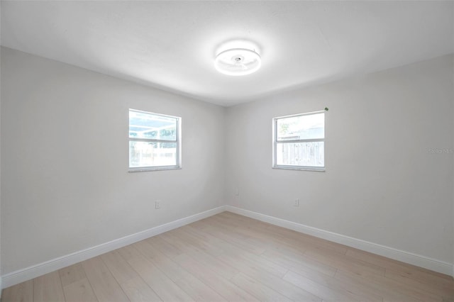 8045 Colton Dr, Port Richey, FL 34668 - unfurnished room featuring healthy amount of natural light and light wood finished floors
