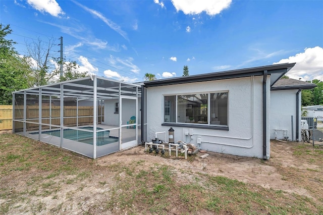8045 Colton Dr, Port Richey, FL 34668 - rear view of house with stucco siding, a lanai, and a patio