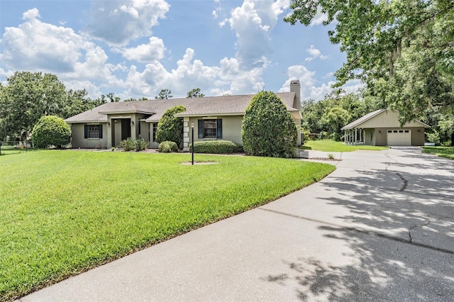 2925 Deerbrook Dr, Lakeland, FL 33811 - ranch-style house featuring driveway, a front yard, stucco siding, and a chimney