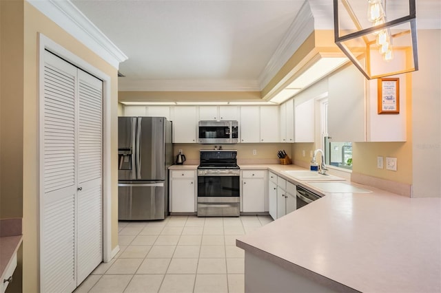 2925 Deerbrook Dr, Lakeland, FL 33811 - kitchen featuring appliances with stainless steel finishes, ornamental molding, light tile patterned floors, white cabinetry, and light countertops