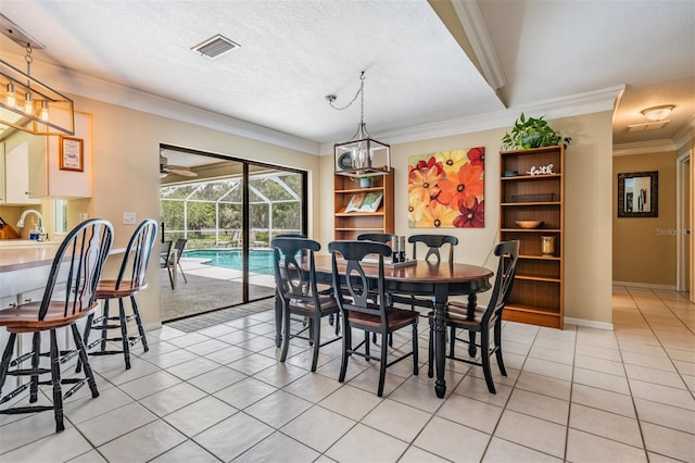 2925 Deerbrook Dr, Lakeland, FL 33811 - dining room with light tile patterned floors, crown molding, and a textured ceiling