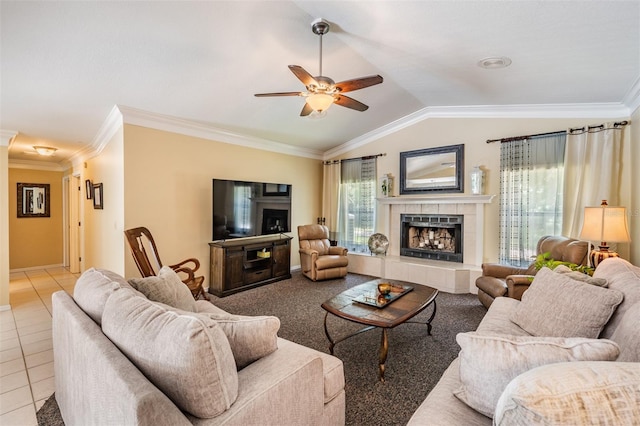 2925 Deerbrook Dr, Lakeland, FL 33811 - living room with a tiled fireplace, a ceiling fan, crown molding, tile patterned floors, and lofted ceiling