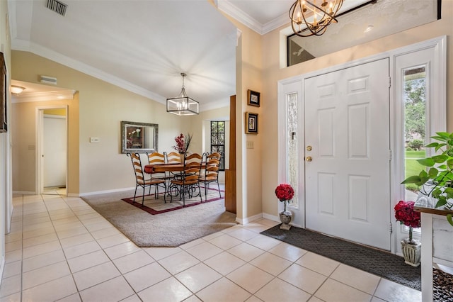 2925 Deerbrook Dr, Lakeland, FL 33811 - foyer entrance featuring a chandelier, lofted ceiling, light tile patterned floors, ornamental molding, and light colored carpet
