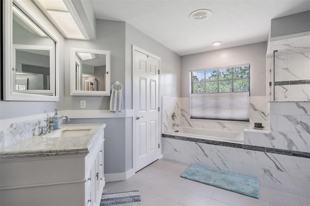2925 Deerbrook Dr, Lakeland, FL 33811 - full bathroom with a bath, vanity, tile patterned floors, and a marble finish shower