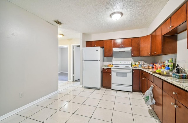7920 N Marks St, Tampa, FL 33604 - kitchen featuring white appliances, under cabinet range hood, a textured ceiling, and brown cabinets