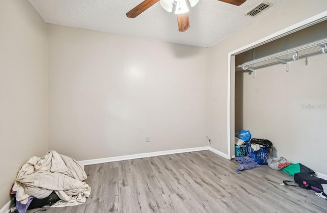 7920 N Marks St, Tampa, FL 33604 - unfurnished bedroom with wood finished floors, a ceiling fan, and a textured ceiling