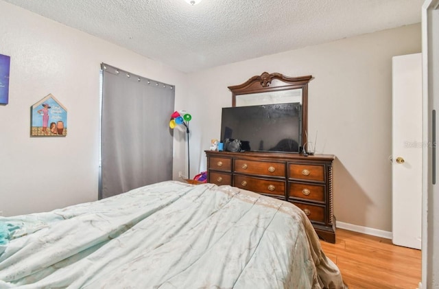 7920 N Marks St, Tampa, FL 33604 - bedroom with wood finished floors and a textured ceiling
