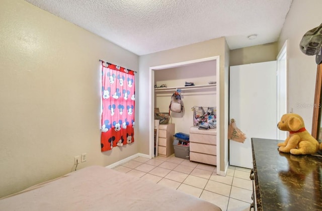 7920 N Marks St, Tampa, FL 33604 - bedroom with a textured ceiling, light tile patterned flooring, and a closet