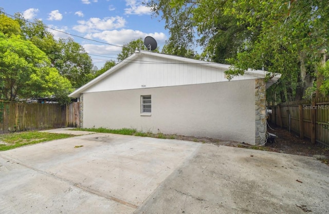 7920 N Marks St, Tampa, FL 33604 - view of side of home with a patio and stucco siding