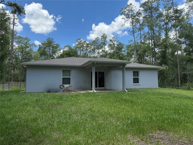 8737 N Spikes Way, Dunnellon, FL 34434 - back of property featuring stucco siding and a patio area