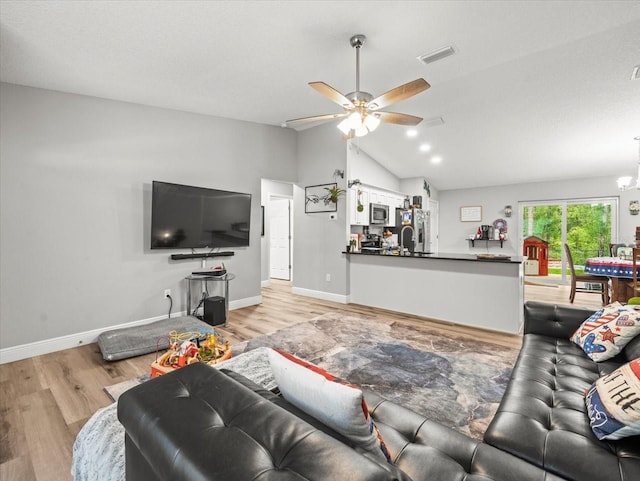 8737 N Spikes Way, Dunnellon, FL 34434 - living room featuring lofted ceiling, light wood-type flooring, a ceiling fan, and a chandelier