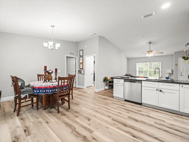 8737 N Spikes Way, Dunnellon, FL 34434 - dining room with light wood finished floors, lofted ceiling, a chandelier, a ceiling fan, and a textured ceiling