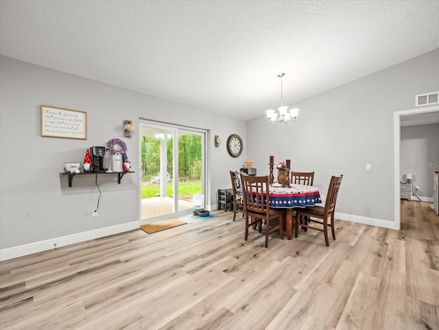 8737 N Spikes Way, Dunnellon, FL 34434 - dining space with wood finished floors, a chandelier, and a textured ceiling