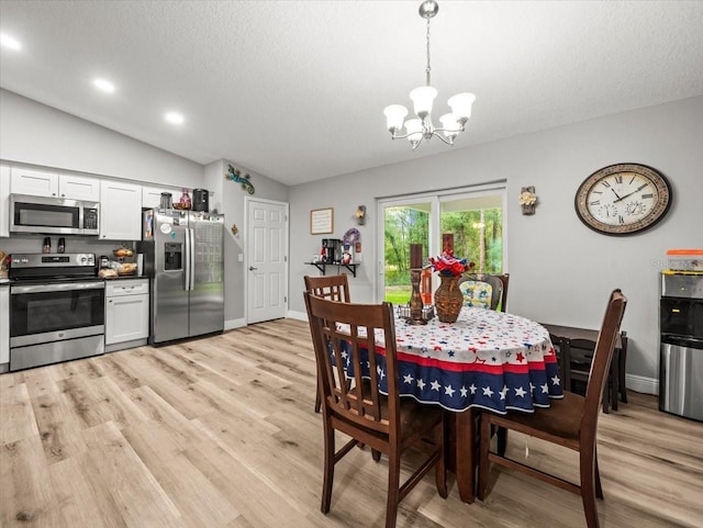 8737 N Spikes Way, Dunnellon, FL 34434 - dining space with a chandelier, light wood-style flooring, lofted ceiling, a textured ceiling, and recessed lighting